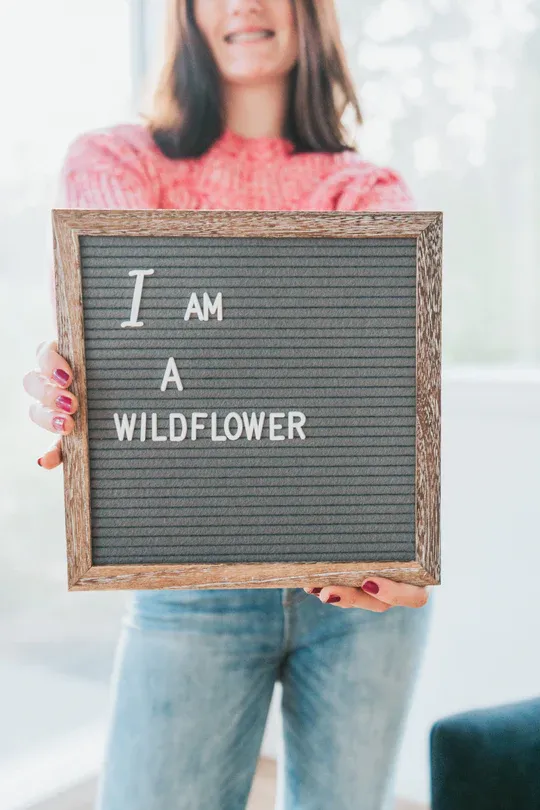 Woman holding sign that reads,