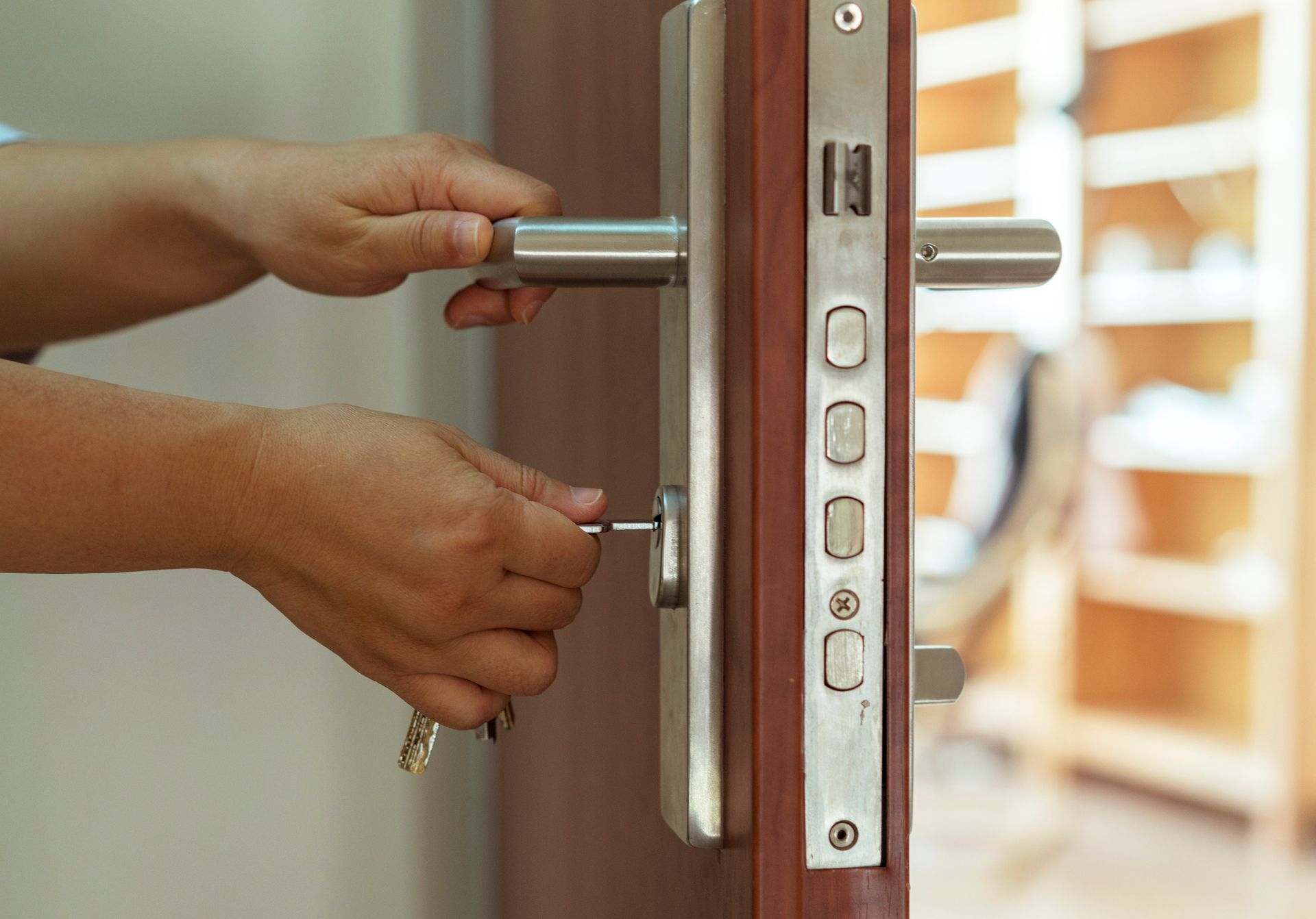 A person is opening a door with a key.