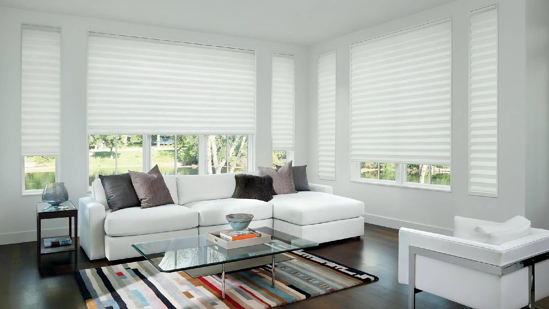 Beautifully designed living room with clean, white shades decorating the windows near Glendora, CA