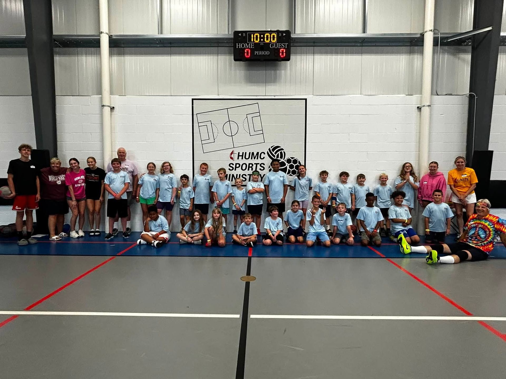 Basketball on a gym floor with kids in the background