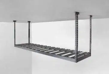 A metal shelf is hanging from the ceiling in a garage.