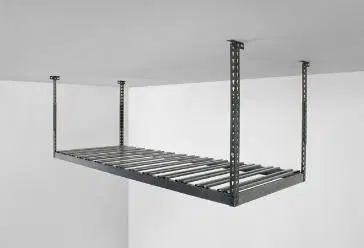 A metal shelf is hanging from the ceiling in a garage.