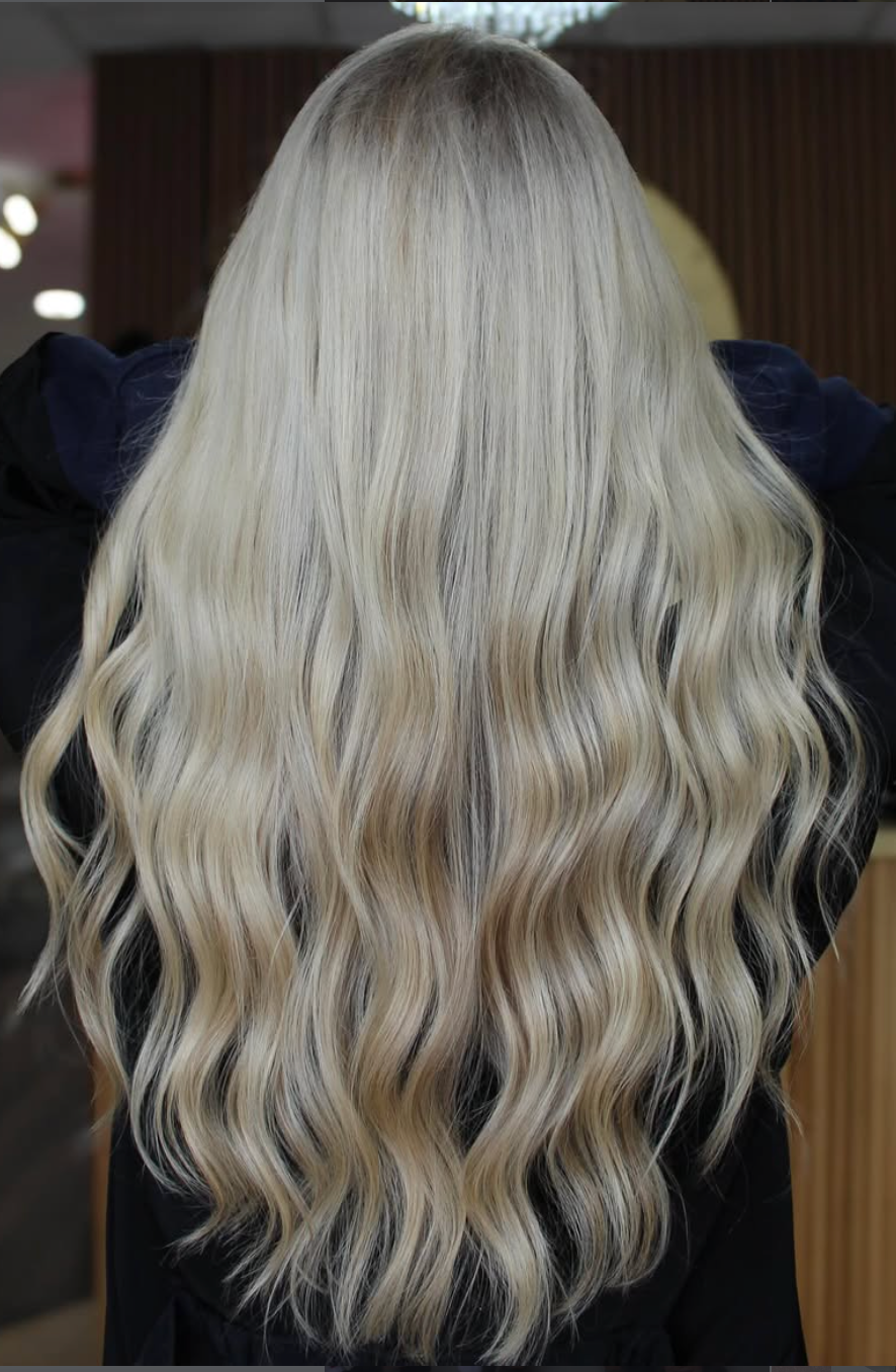 Long wavy platinum blonde hair shown from the back