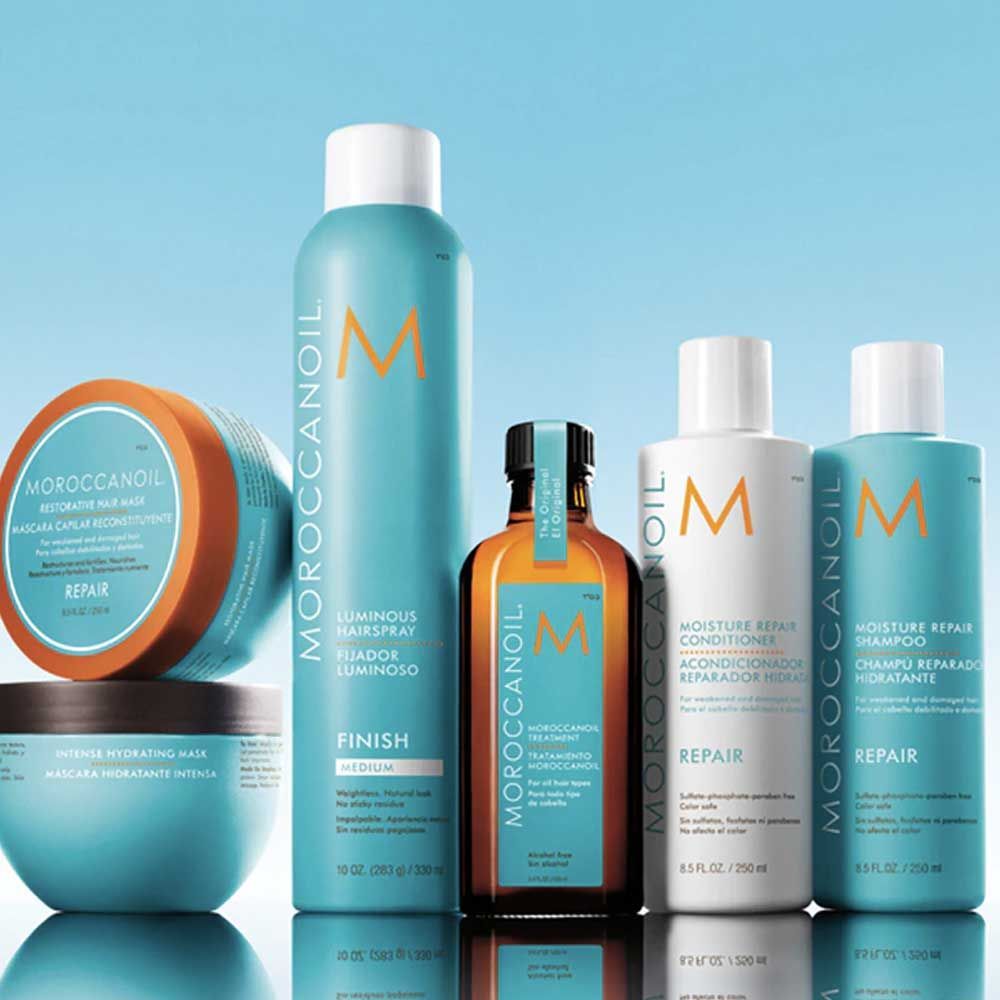 Assorted ELEVEN hair products with pink, white, and orange packaging, including shampoo, conditioner, and comb