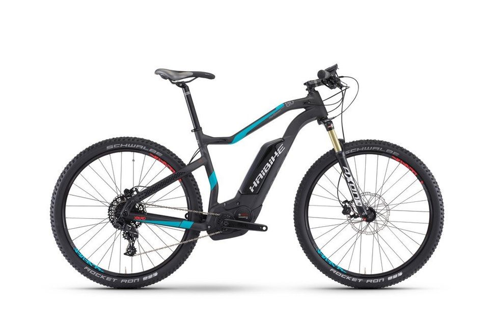 A black and blue electric mountain bike on a white background.