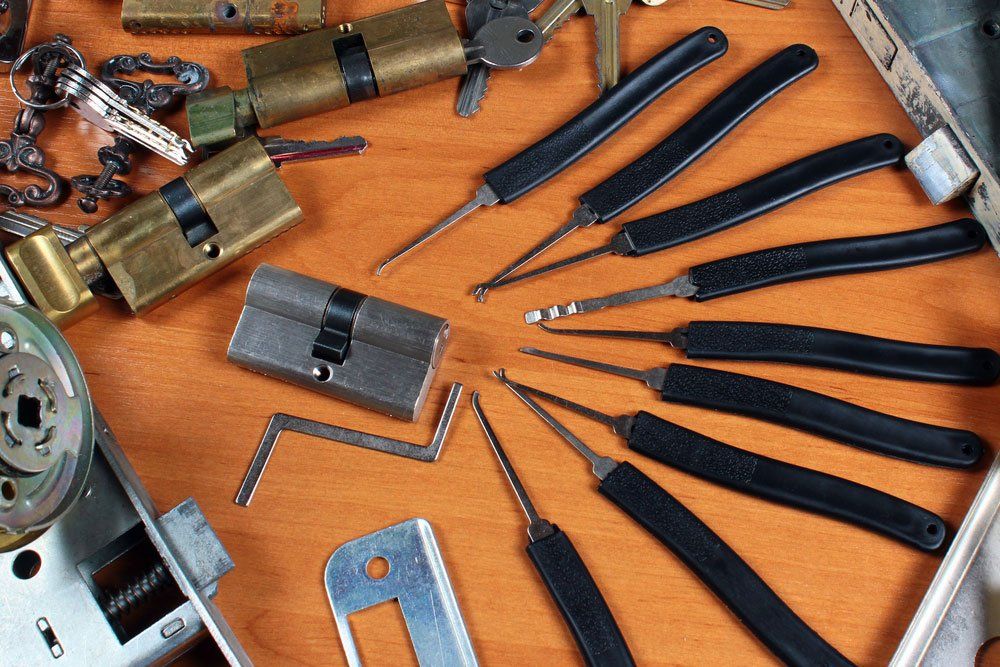 Lock Picking Tools and Keys on a Wooden Surface — Lake Macquarie Mobile Locksmiths in Murray Beach, NSW