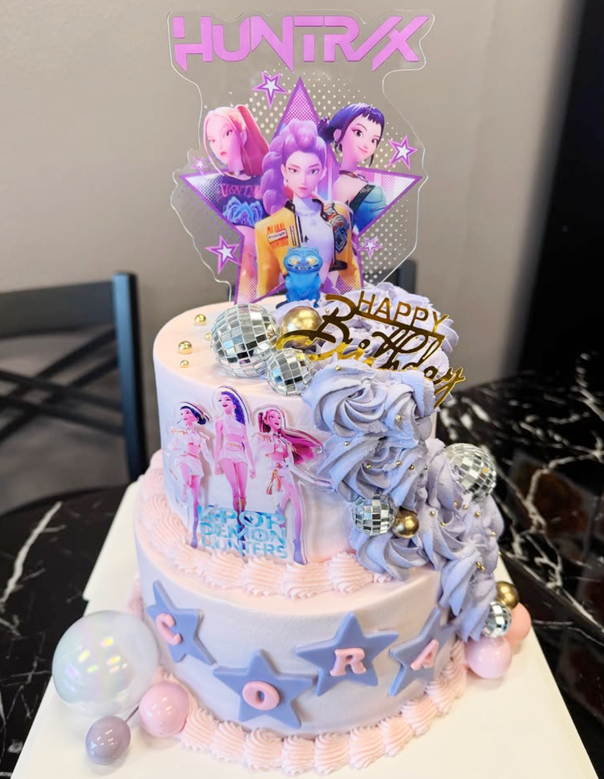 Two-tiered cake with animated character toppers and 