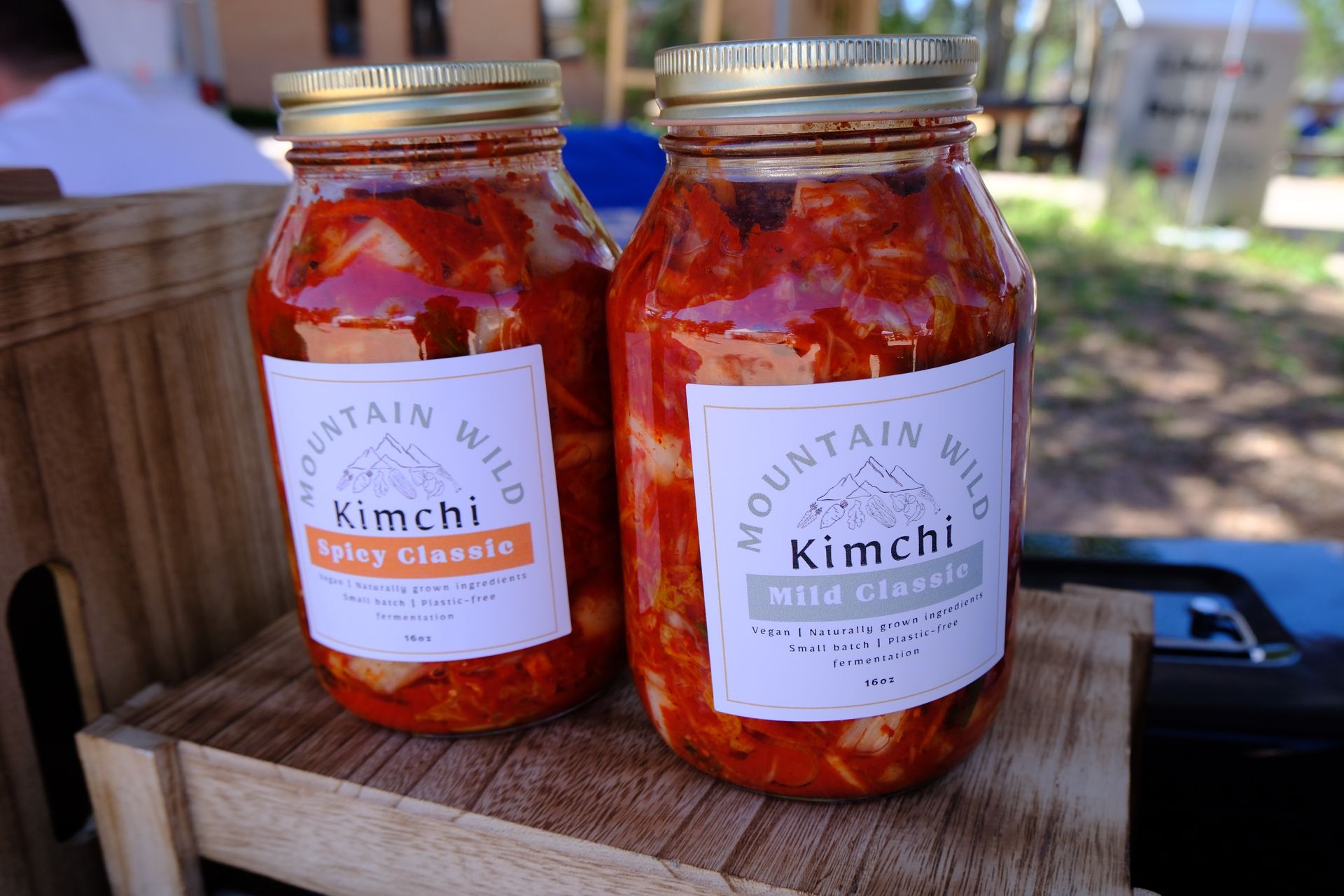 Two glass jars of kimchi with labels, 