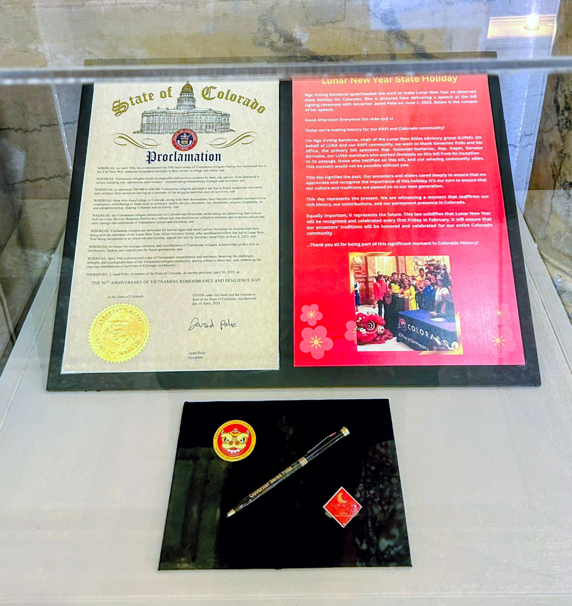 A State of California proclamation and a commemorative pen in a display case.