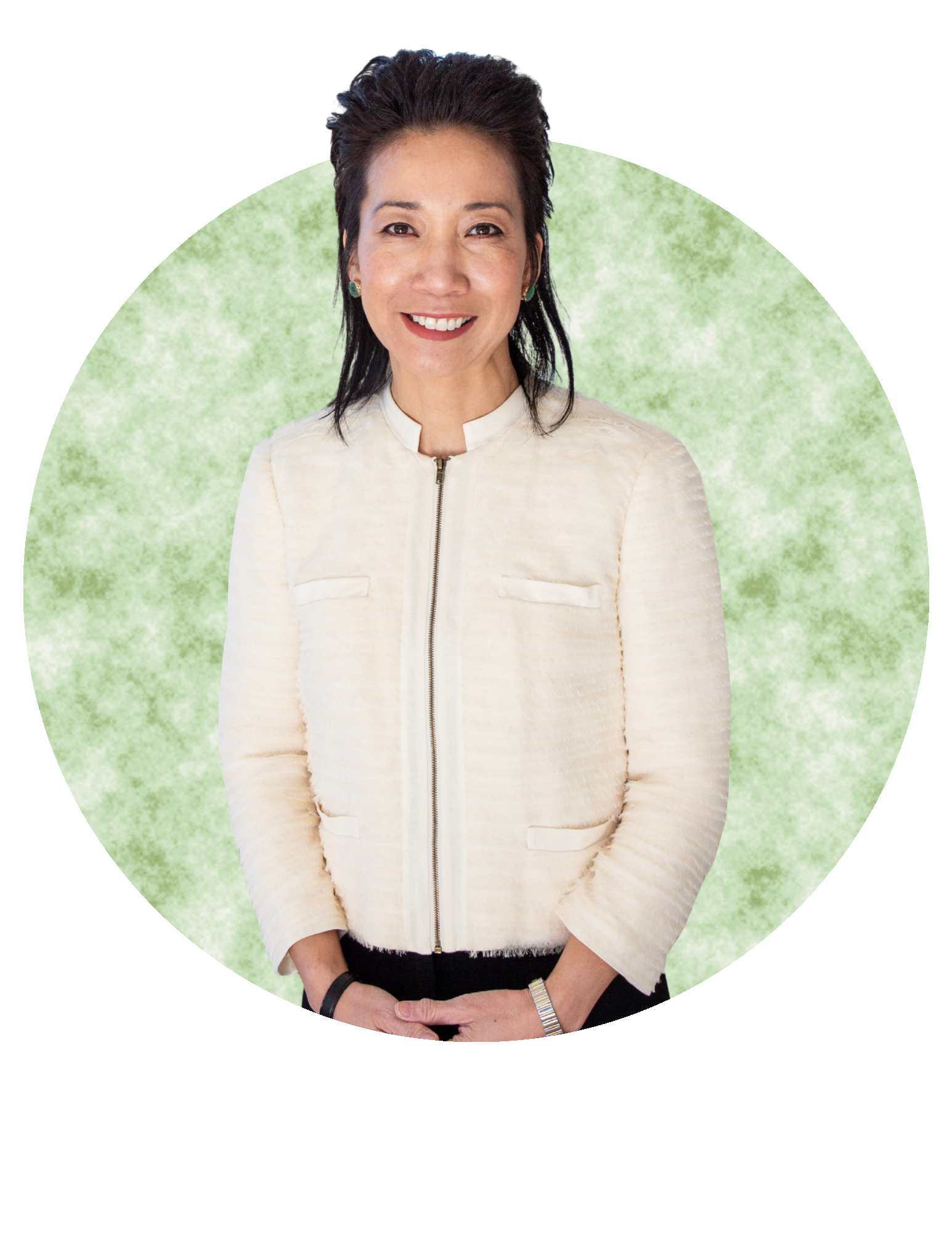 Smiling person in a cream jacket against a pale green circular backdrop