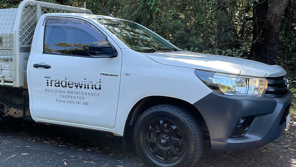 A White Truck Is Parked on The Side of The Road — Tradewind Building Maintenance in Woonona,NSW