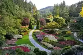 A picture of the butchart gardens in Victoria BC. The flowers are in bloom and the colours of red, pinks, purples, and whites are spread throughout the landscape.