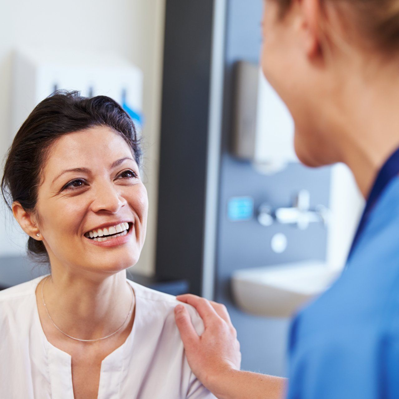 Nurse and patient smiling