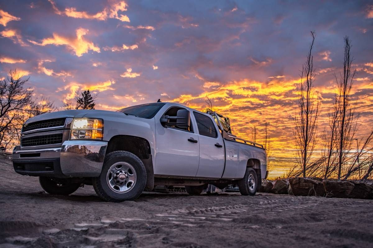 A heavy-duty pickup truck on a hill during sunset at Mr. Transmission near Sharonville, OH