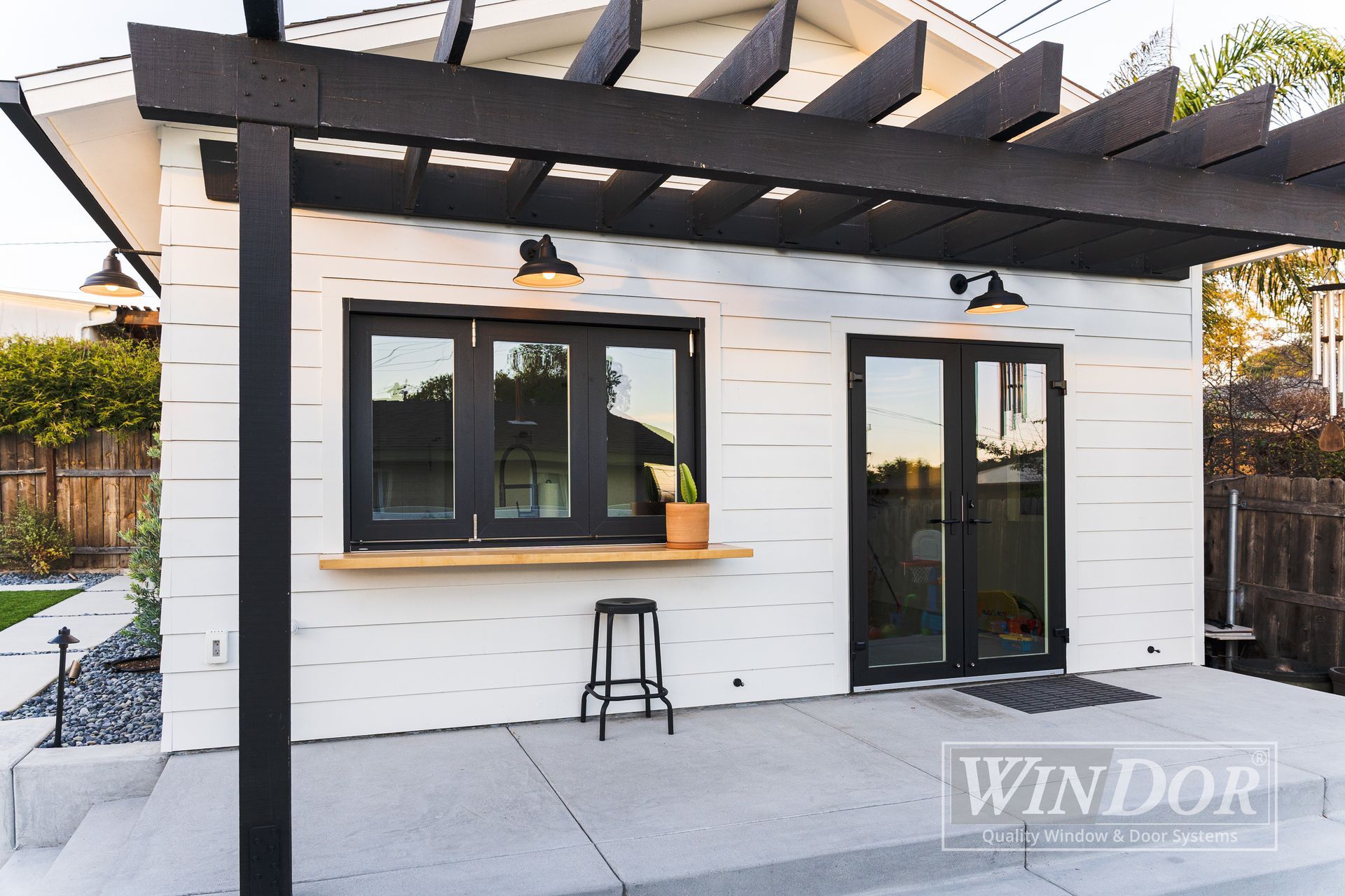 modern home doors feature a black aluminum frame with large glass panes