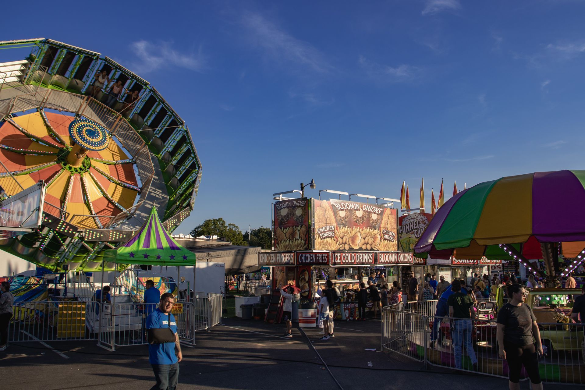 A group of people are walking around a carnival.