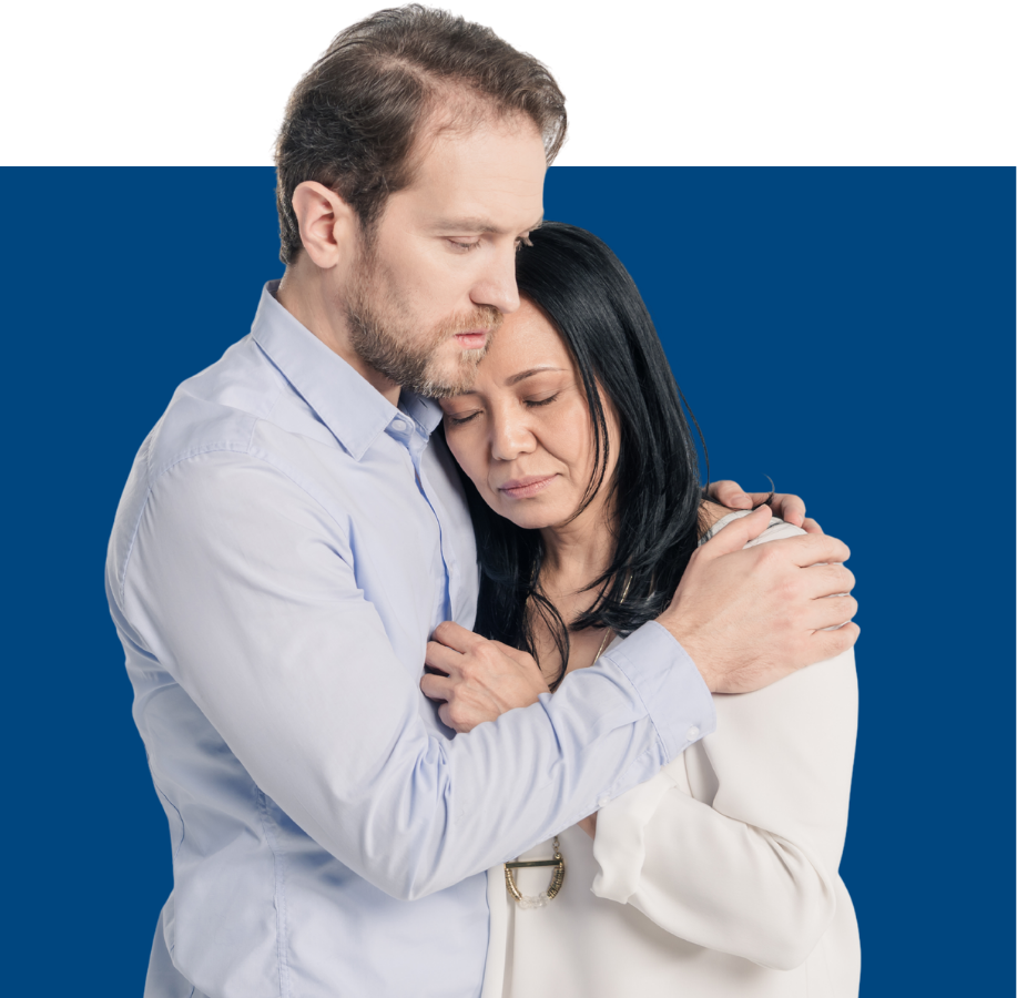 man comforting woman with blue background