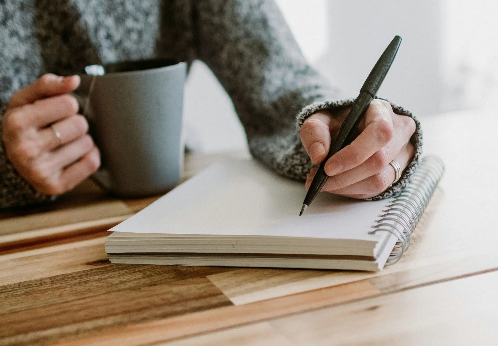 close up of person writing in a notebook