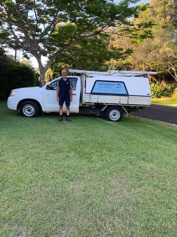 A Man Is Standing in Front of A White Truck — Natraspray Lismore in Byron Bay, NSW