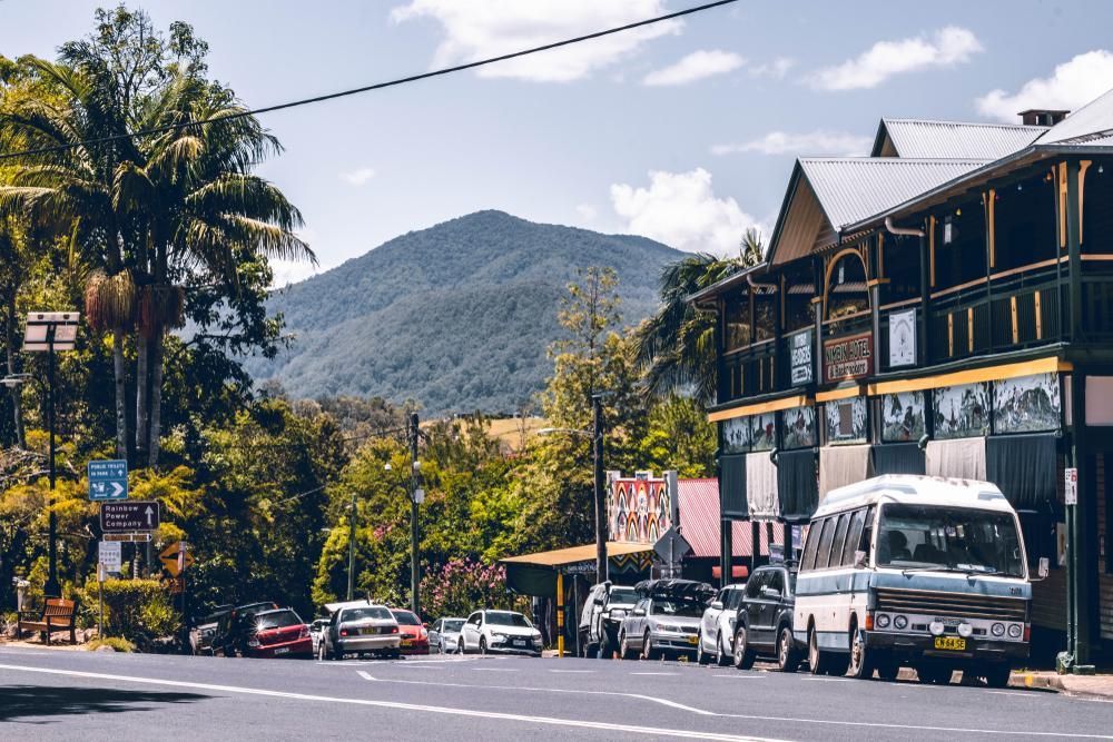 A Row of Cars Are Parked on The Side of The Road in A Small Town — Natraspray Lismore in Nimbin, NSW