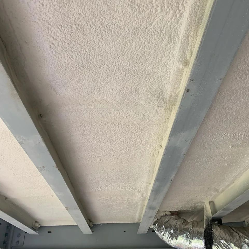 White textured ceiling with gray beams.