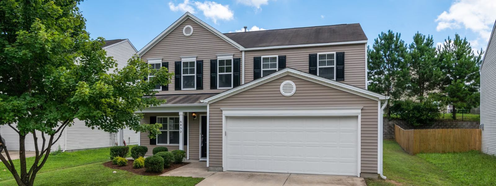 Two-story home with fresh vinyl siding under a blue sky, vinyl siding in Maryville, TN, Heavy Dutys