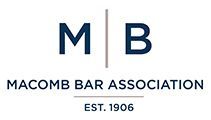 Macomb Bar Association logo with navy M B monogram and EST. 1906 text on white background