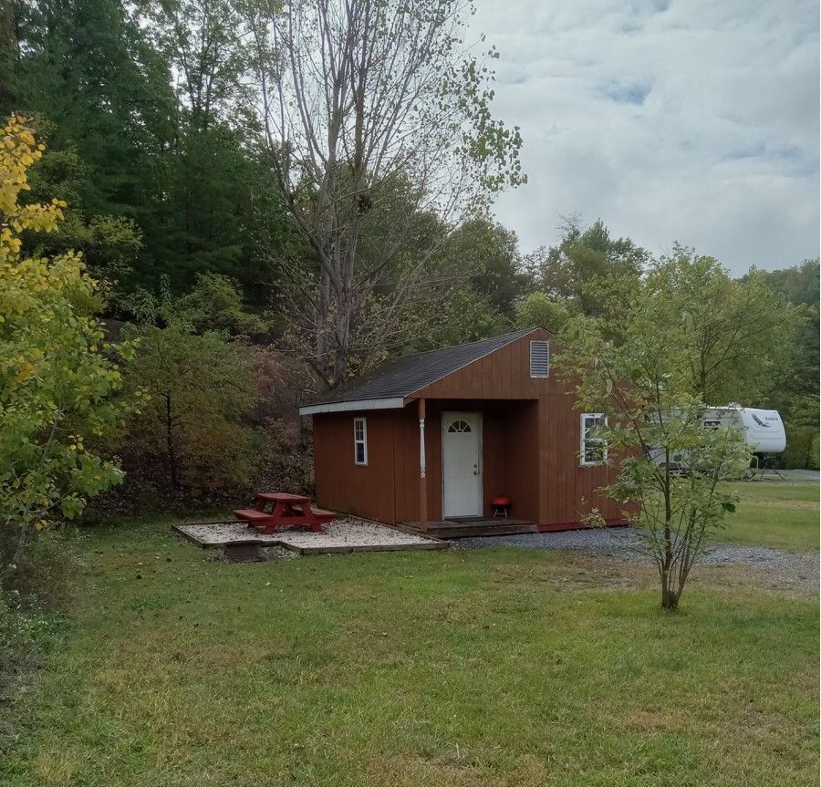 A small house with a picnic table in front of it