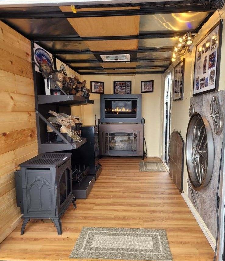 A living room with a fireplace and a television — Glen Burnie, MD — McAllister Plumbing Inc.