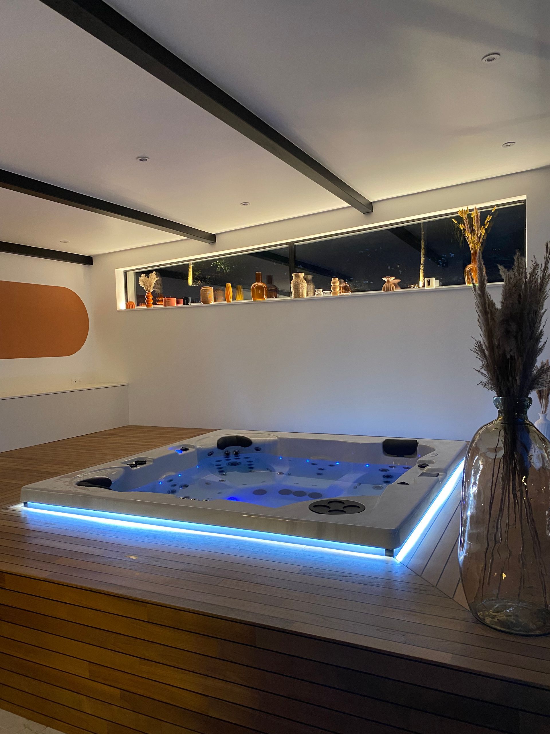 Il y a un grand jacuzzi au milieu de la pièce.