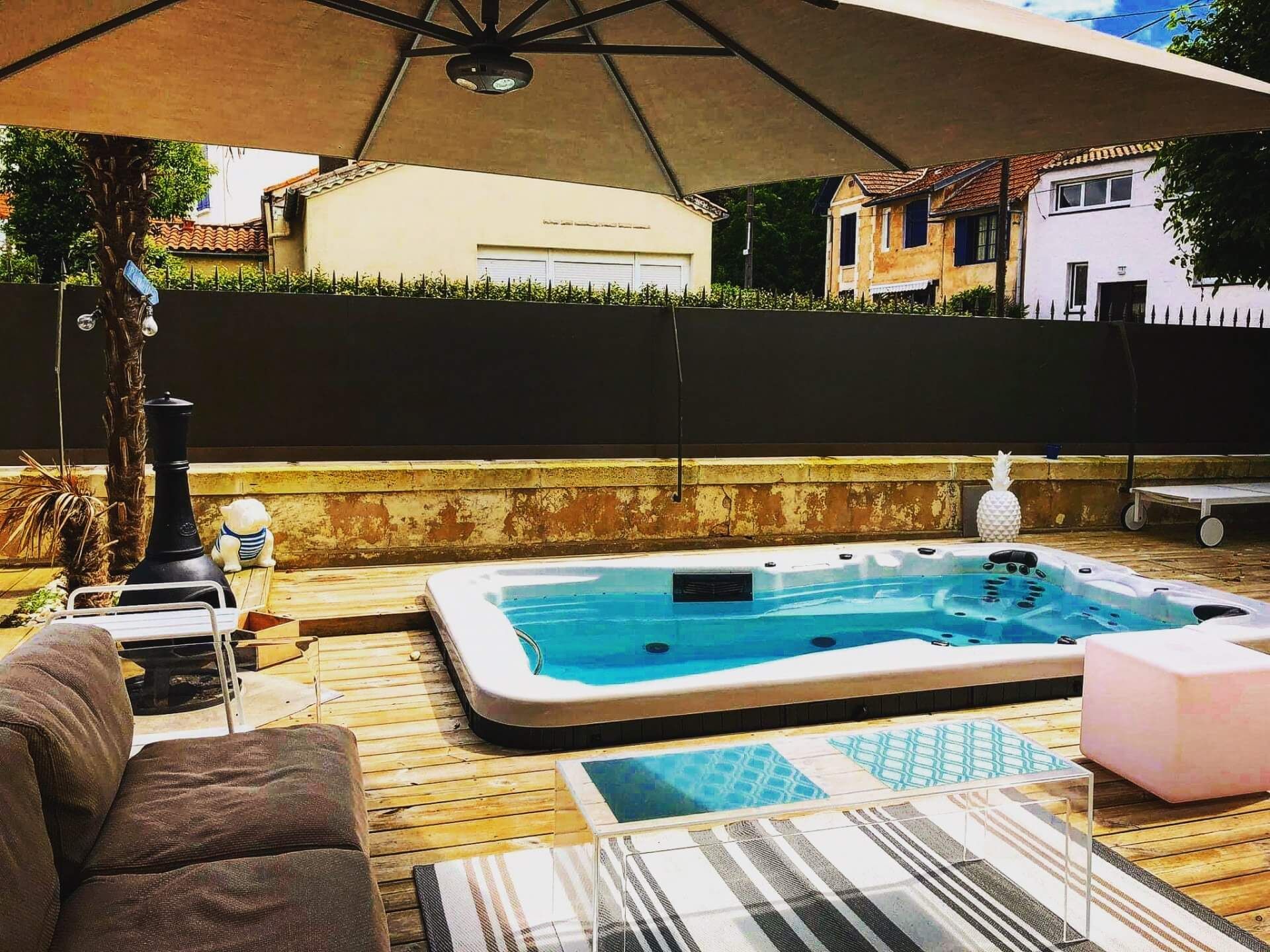 Une piscine avec un grand parasol au-dessus