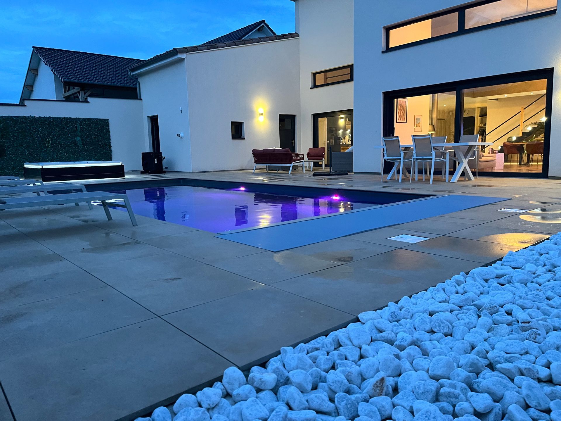 Une grande maison blanche avec une piscine devant