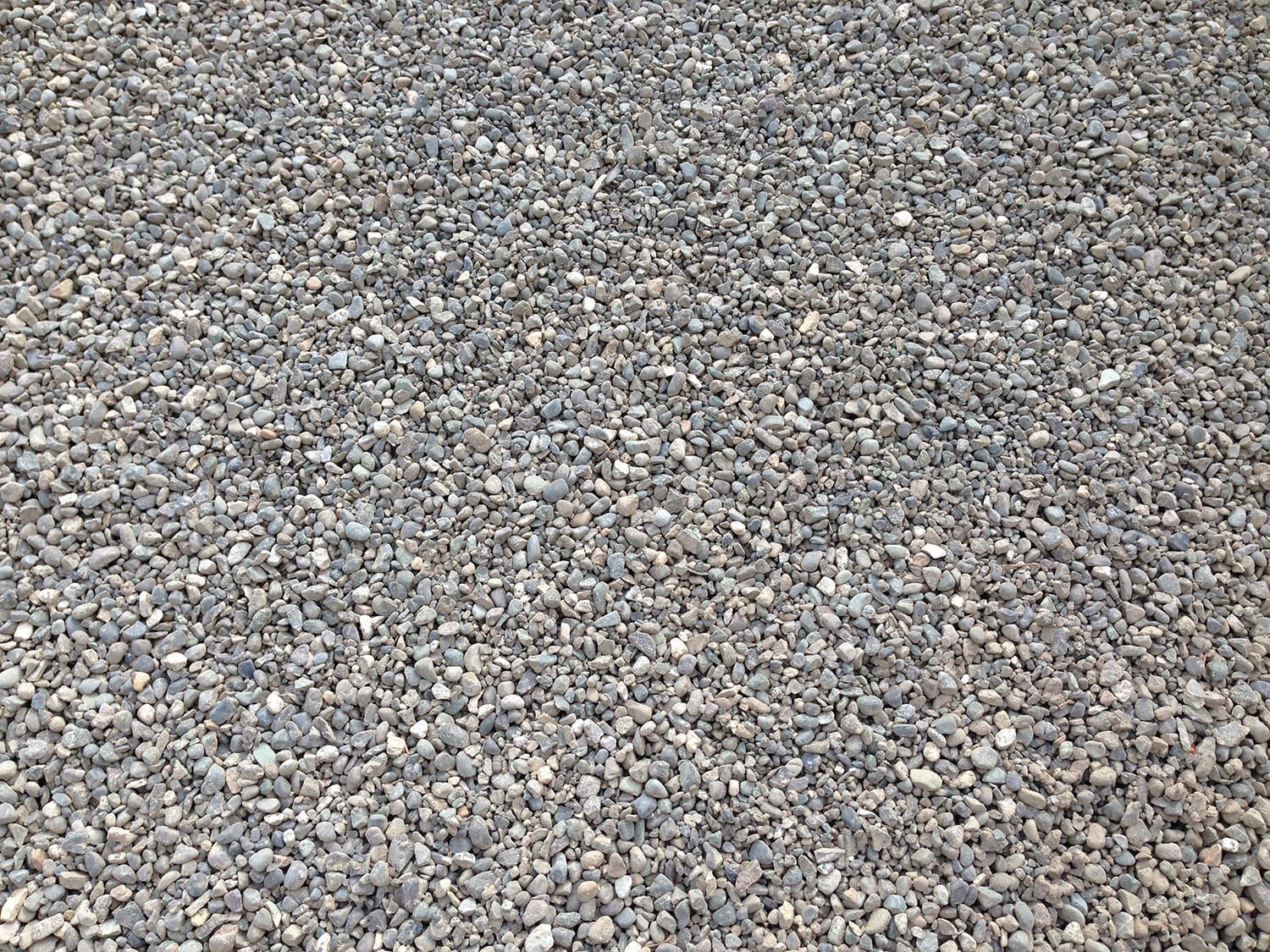 A pile of gravel is sitting on the ground.