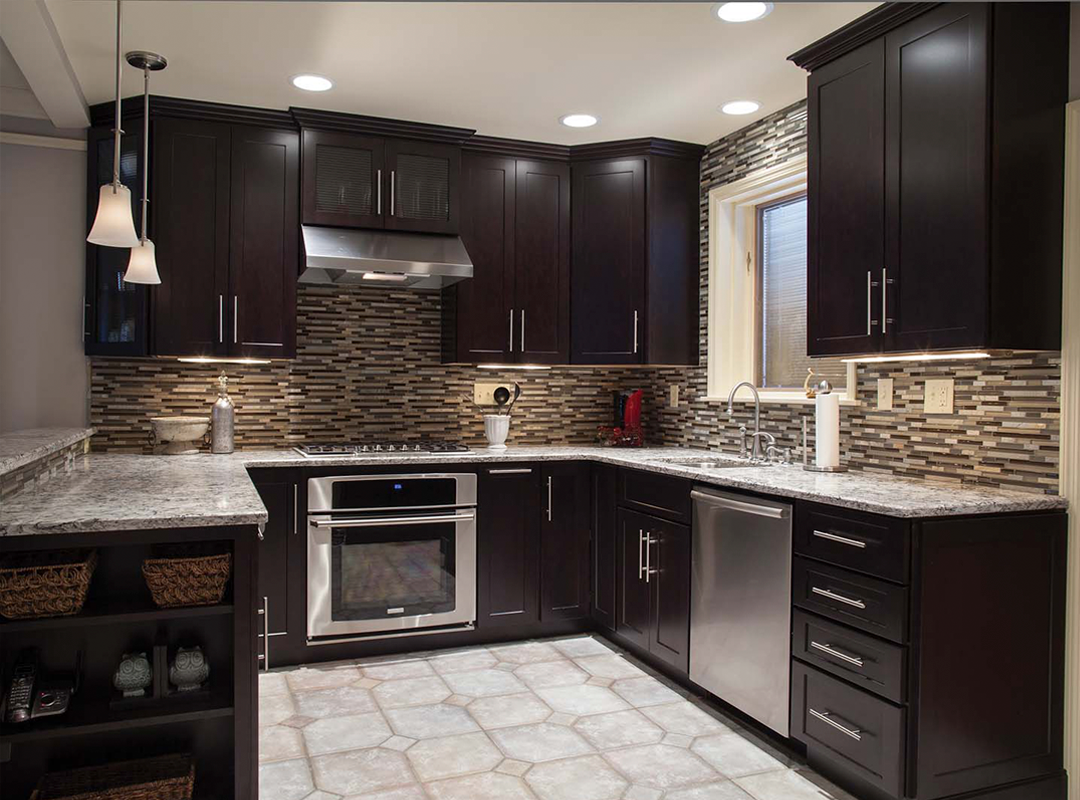 Dark brown kitchen with stone backsplash, stainless steel appliances, and granite countertops.