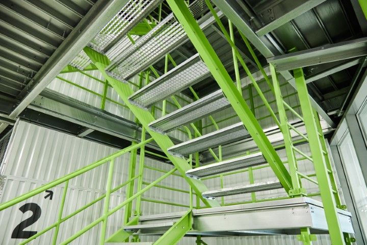 Green metal staircase inside an Oro Valley building