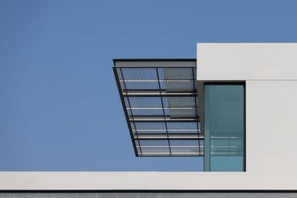 White building corner with a metal awning