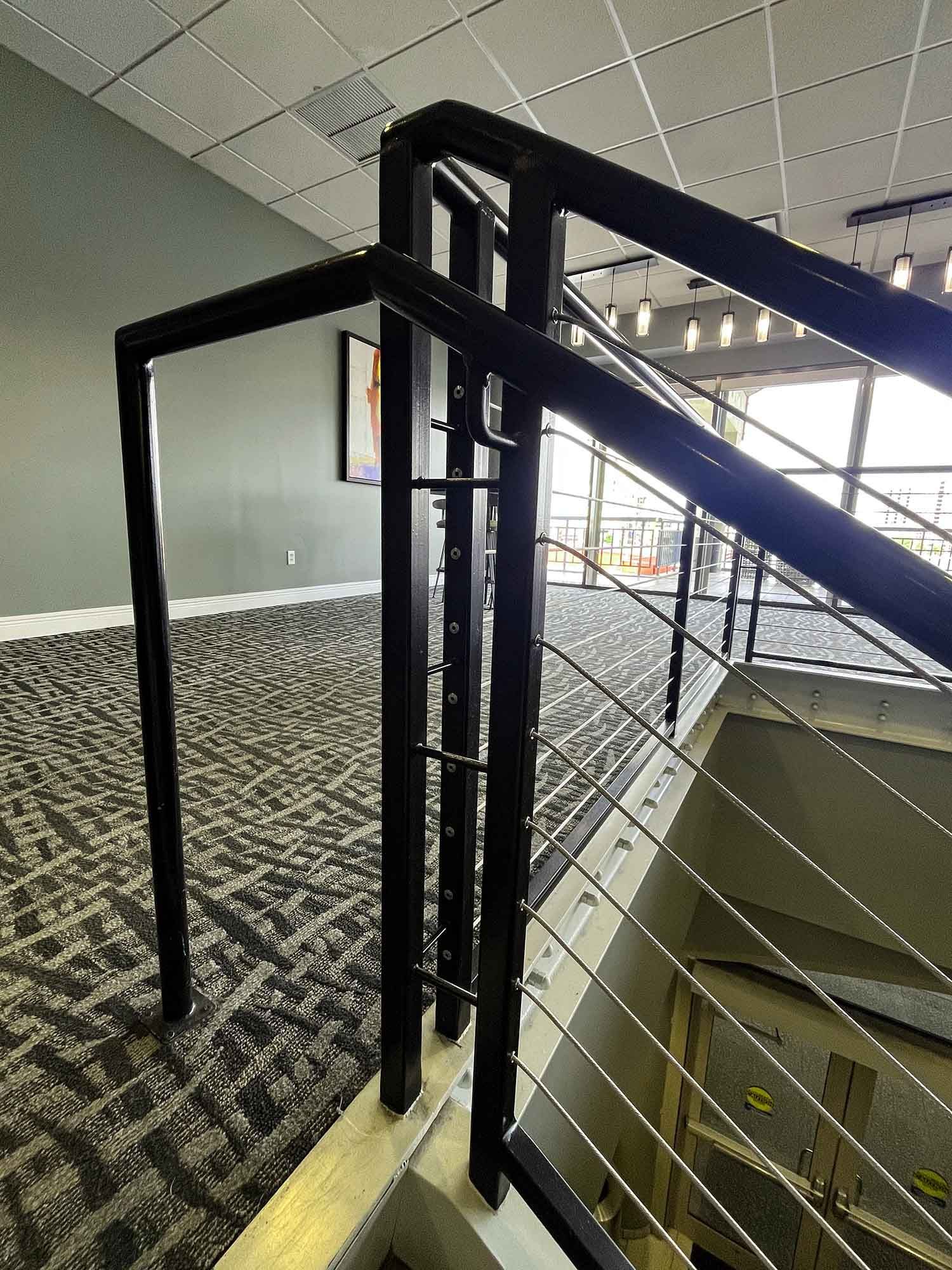 black aluminum, silver cable railing in public stairs