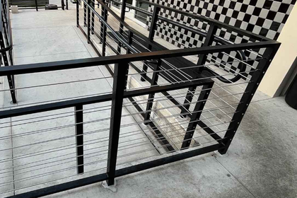 cable rails wrapping around a concrete ADA ramp
