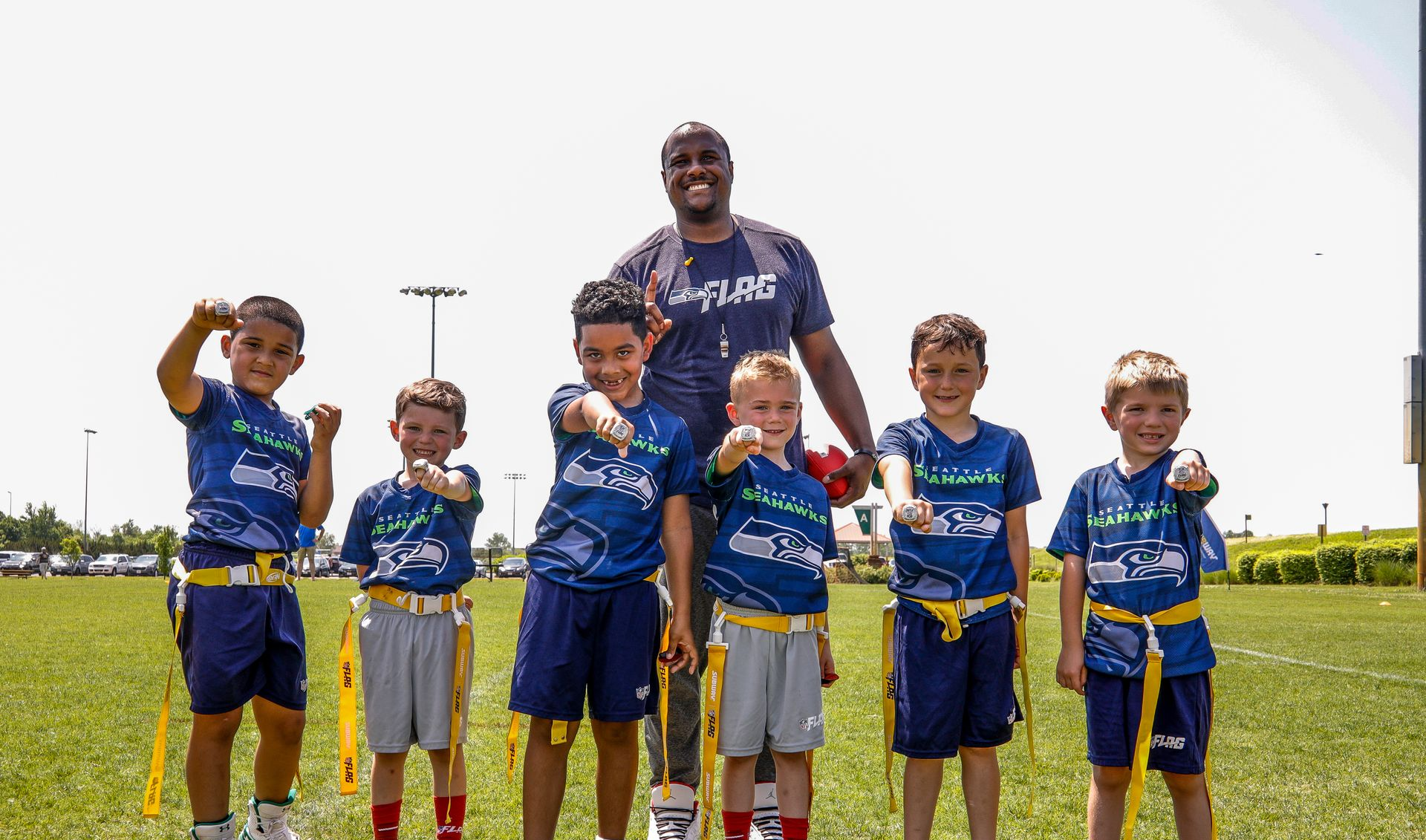 Diverse group of kids in colorful NFL FLAG football jerseys