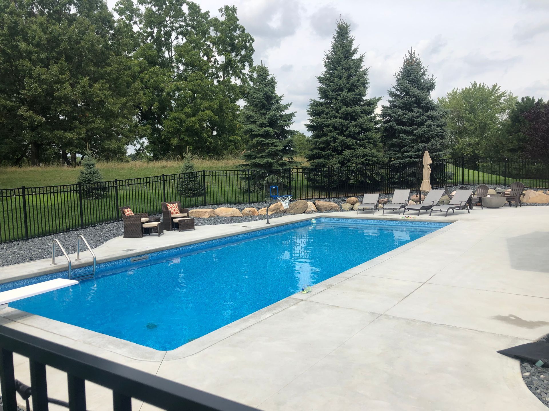 Outdoor In-ground pool with diving board and games