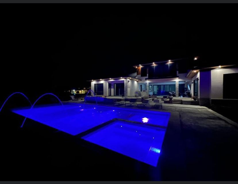 Outdoor In-ground pool at night