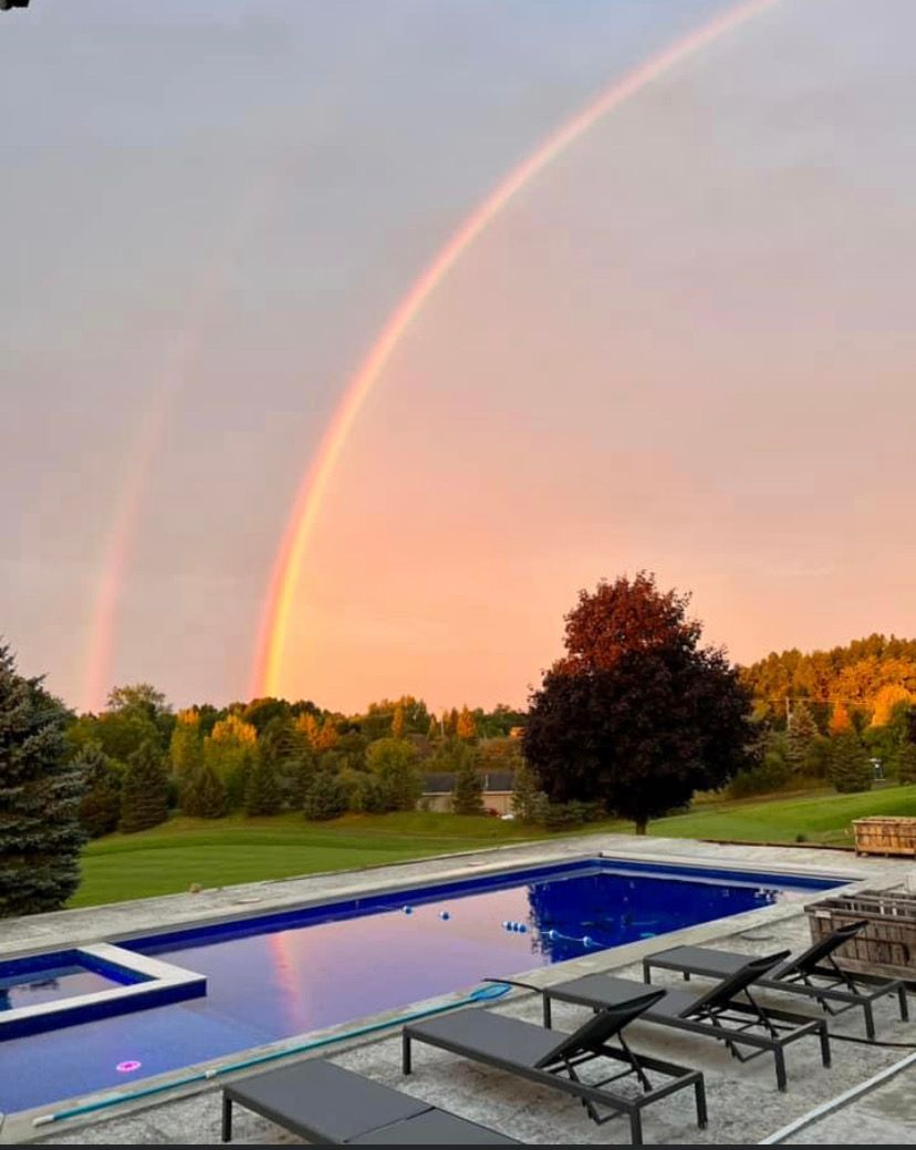 Outdoor In-ground pool with rainbow