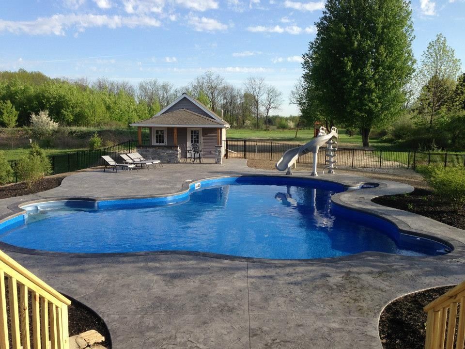 Outdoor In-ground pool with fountains and waterfall