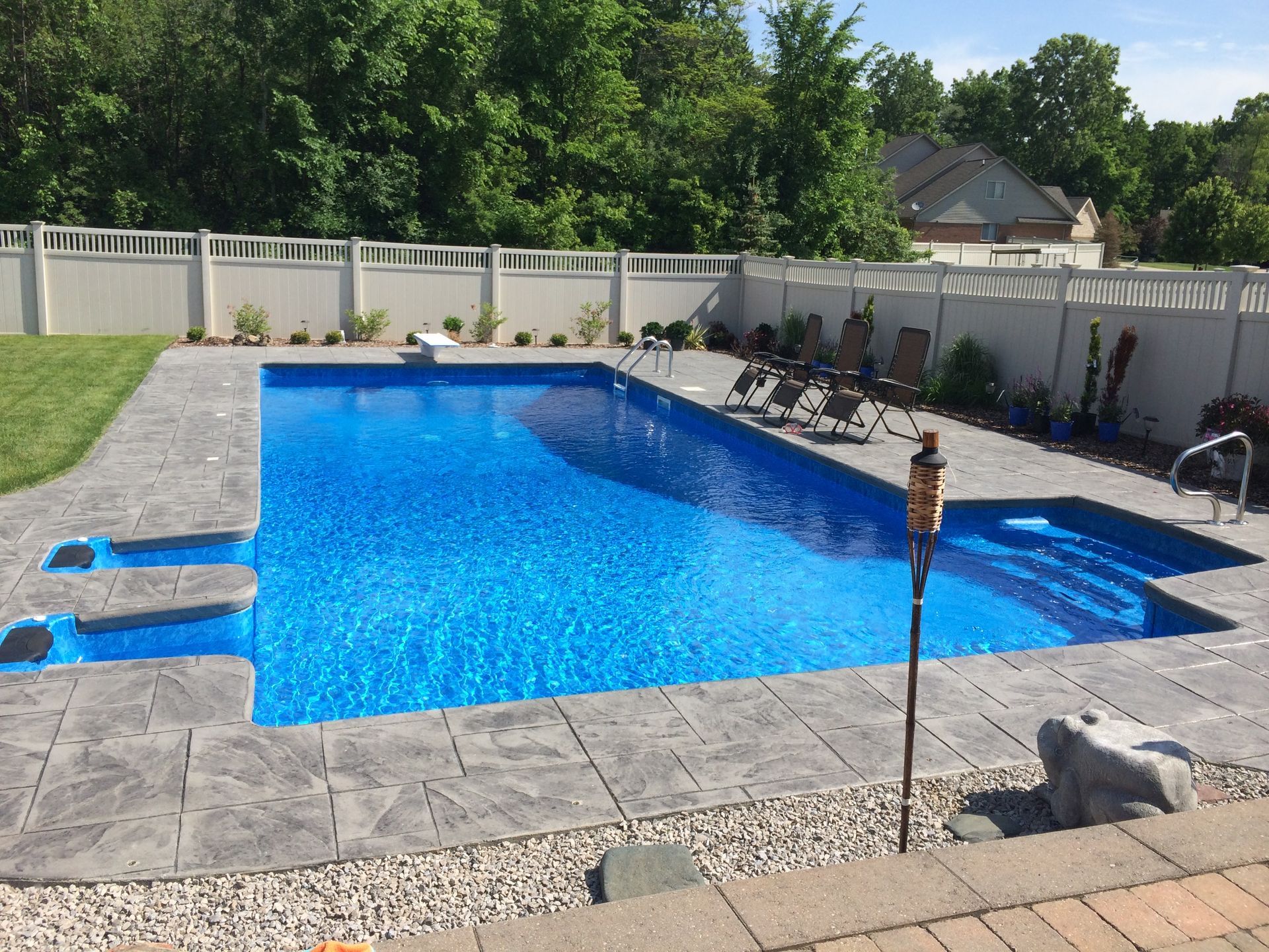 Outdoor In-ground pool with jets far view