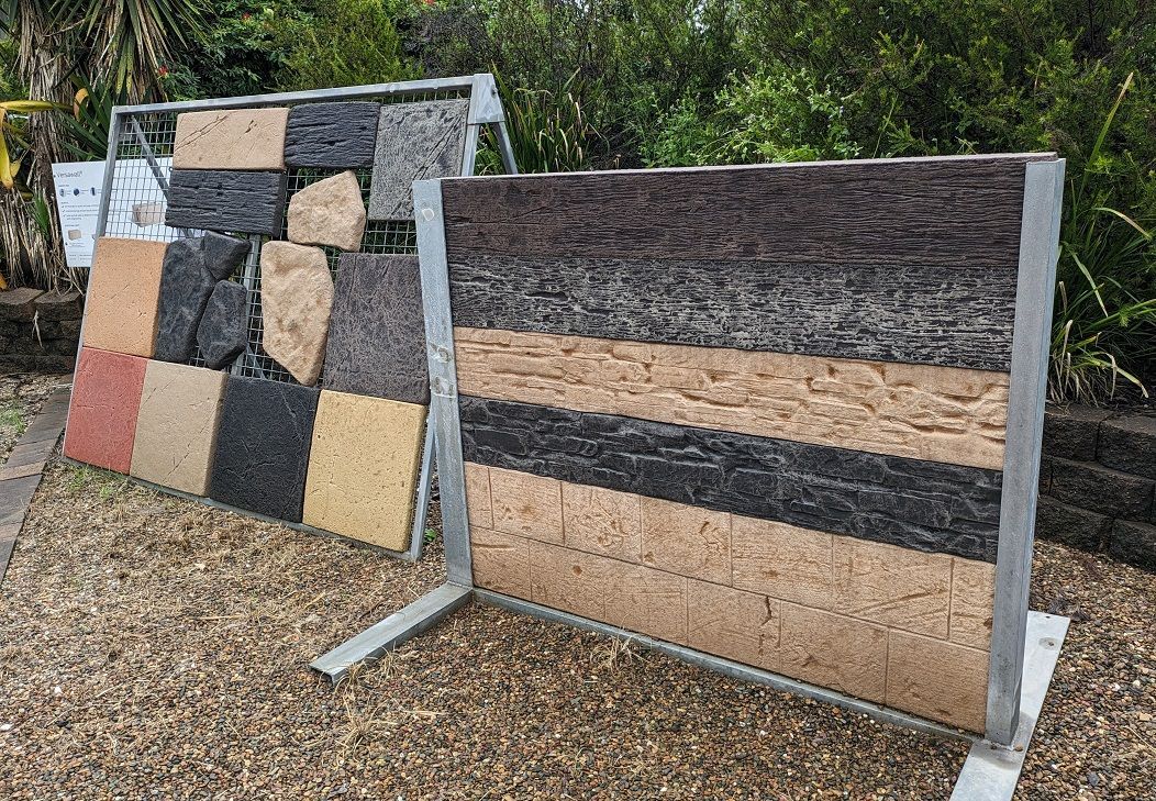 A Man is Standing Next to a Large Brick Wall — Golden City Brick & Landscape in Gympie, QLD