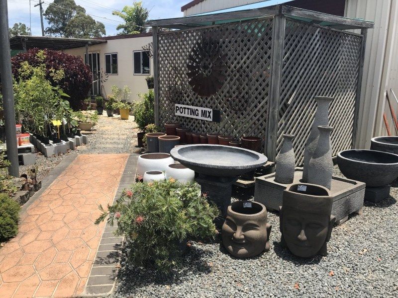 A Bunch of Pots and Vases Are Sitting in Front of a Building — Golden City Brick & Landscape in Gympie, QLD
