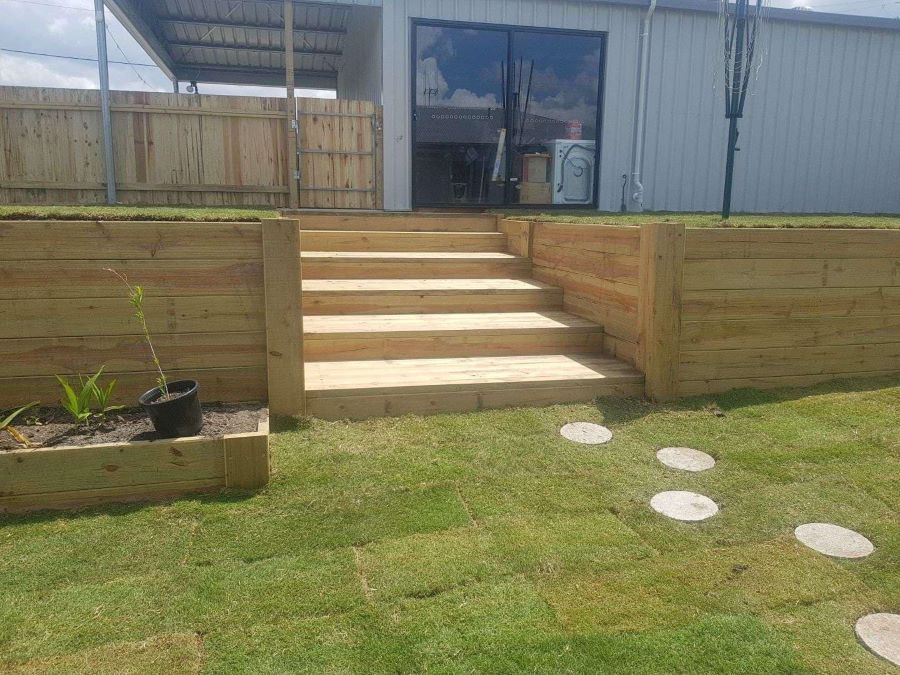 A Wooden Staircase Leading Up to a House in a Backyard — Golden City Brick & Landscape in Gympie, QLD