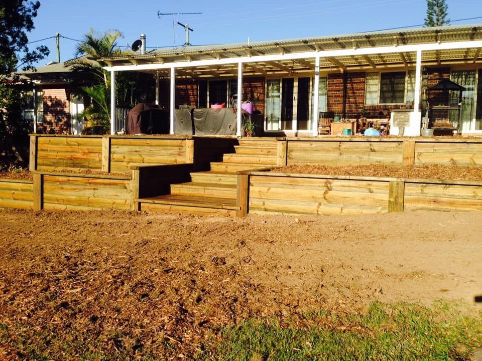 A Lot of Crates Are Sitting on the Ground in a Gravel Area — Golden City Brick & Landscape in Gympie, QLD