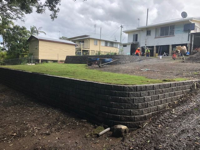 A Brick Wall With Stairs Leading Up to a House — Golden City Brick & Landscape in Gympie, QLD