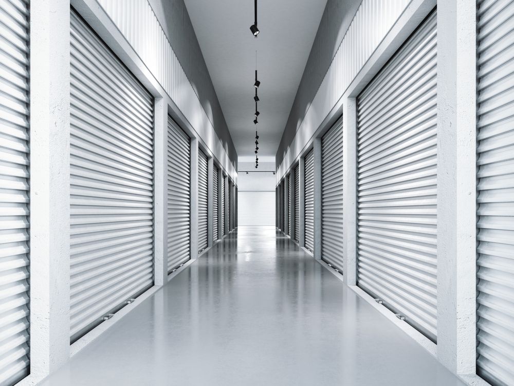 A Perspective View Down a Hallway Lined With Roll-up Storage Unit Doors — King Street Storage Emerald in Emerald, QLD